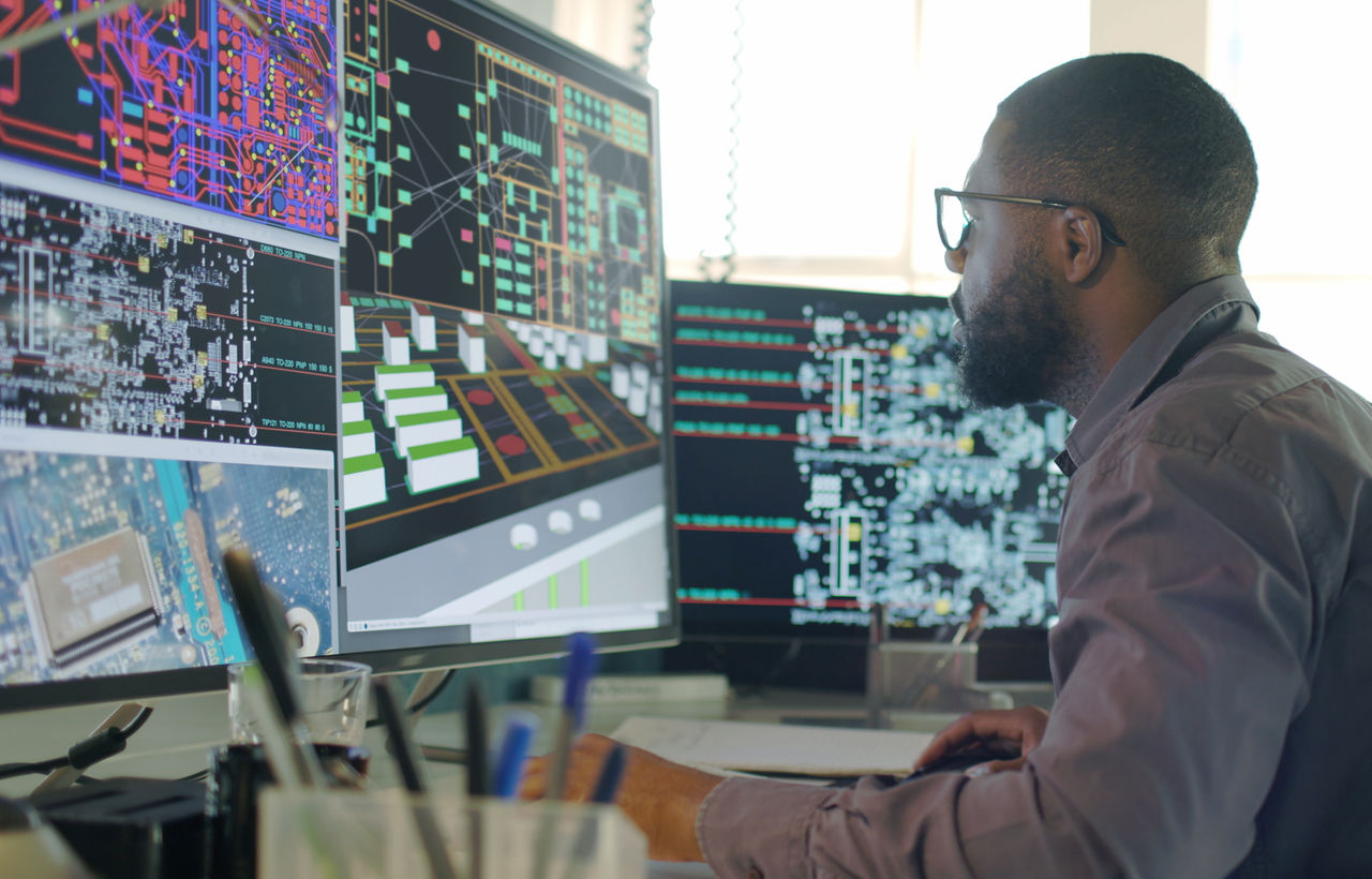 Engineer at computer using digital engineering tools. 