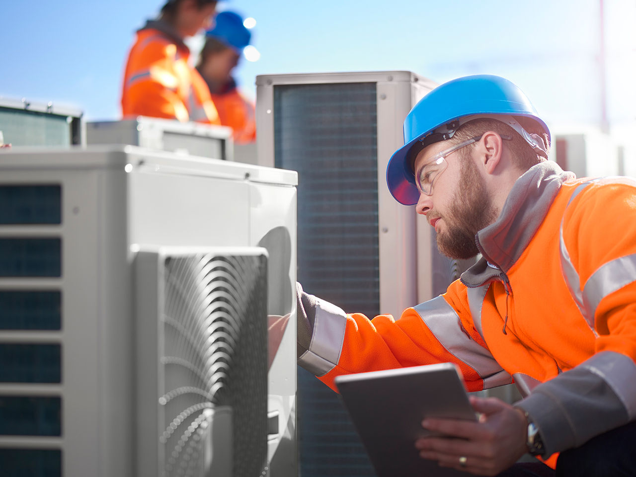 Technician servicing an HVAC unit. 