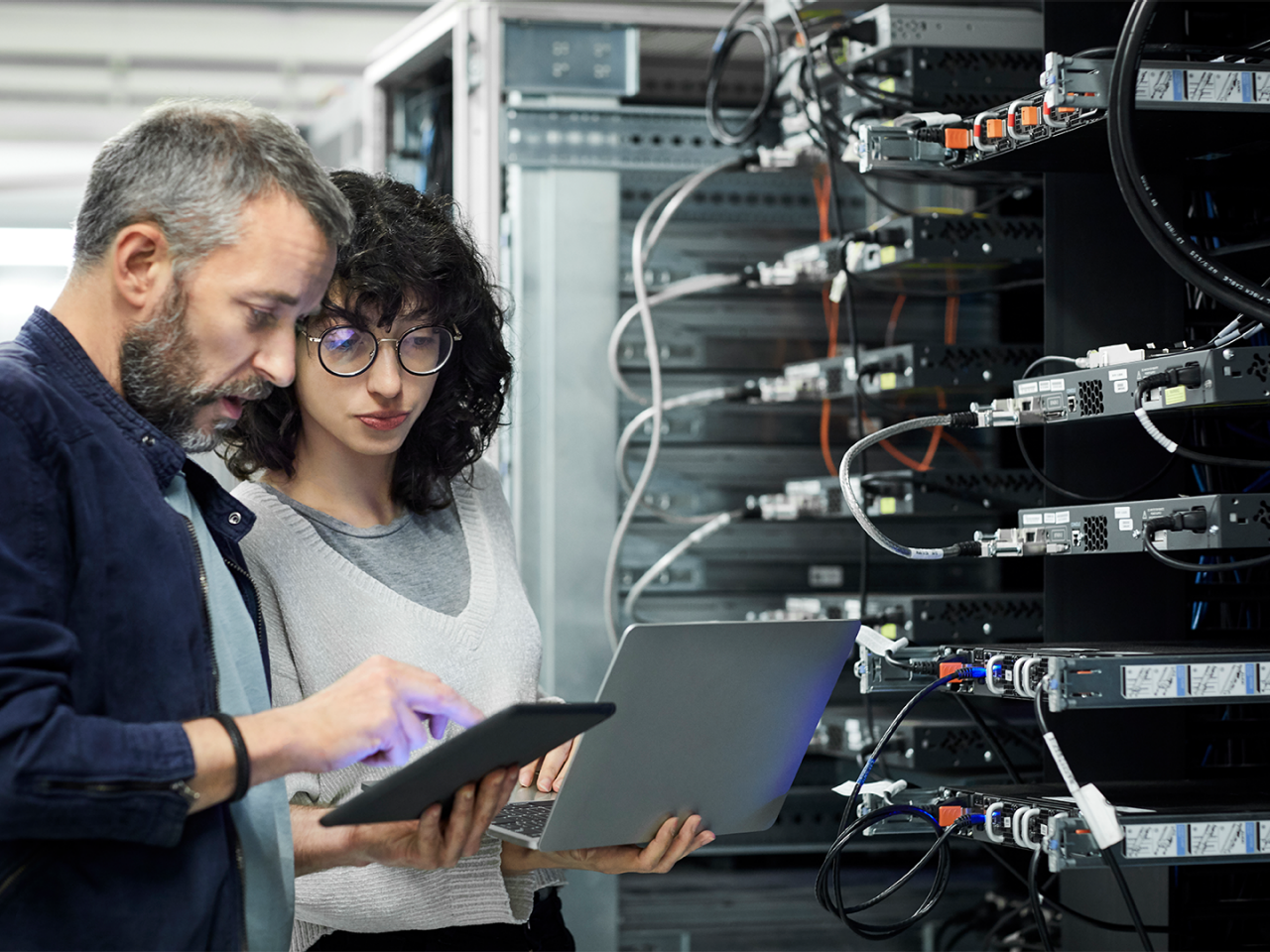 Data center technician discussing co-packaged optics with co-worker.