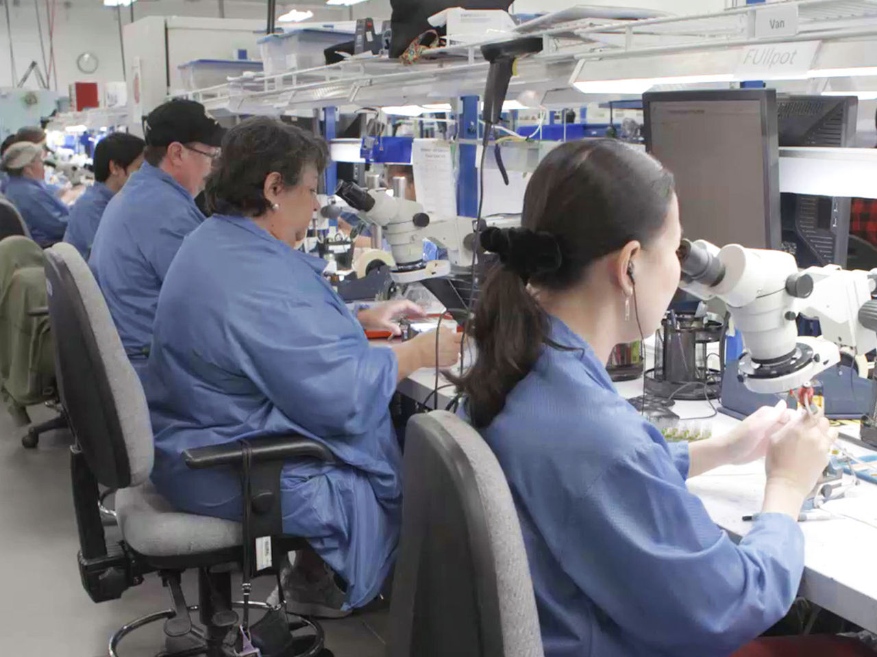 Workers assembling components on the AirBorn factory production line.  