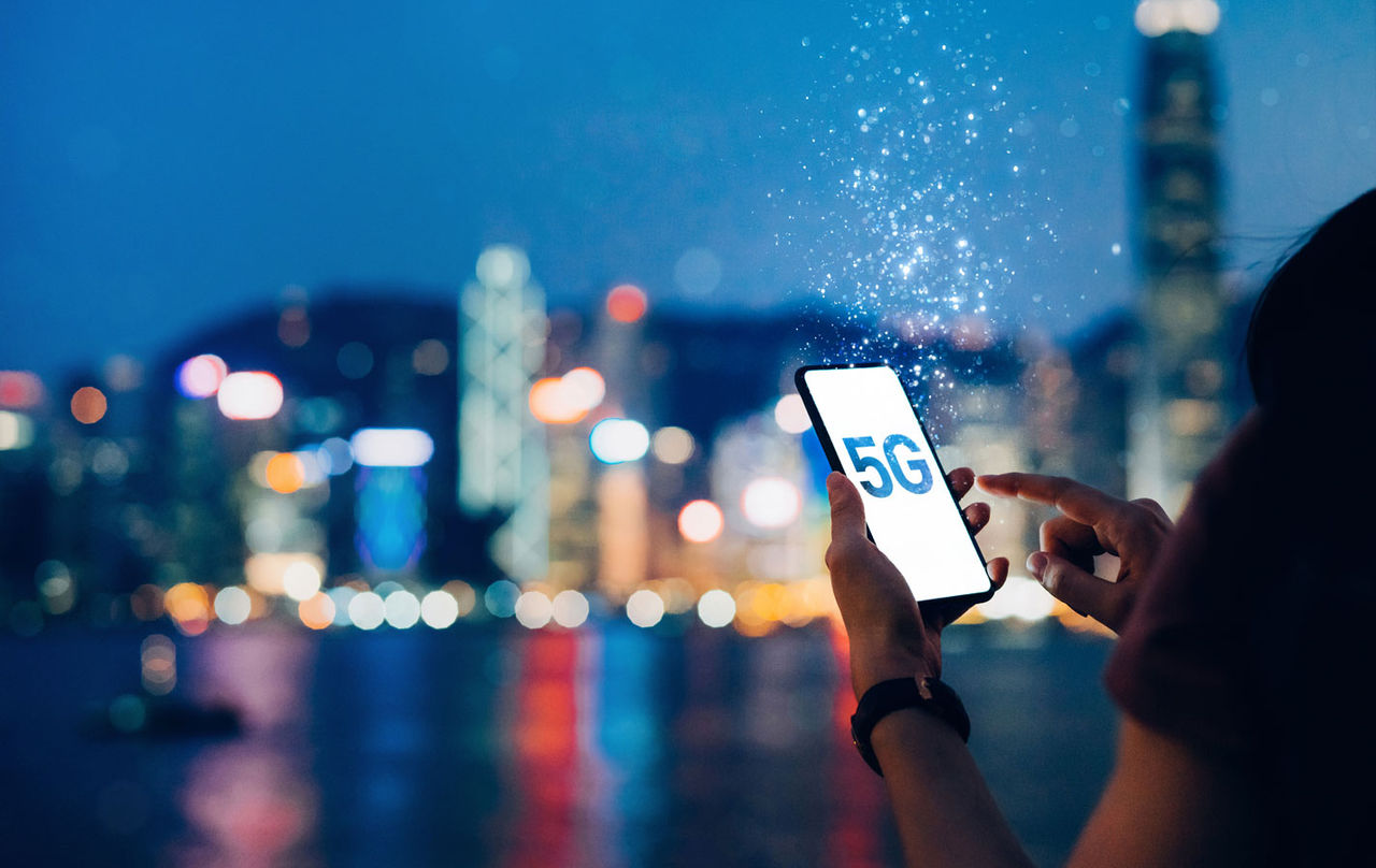 A person using a 5G-enabled mobile phone.