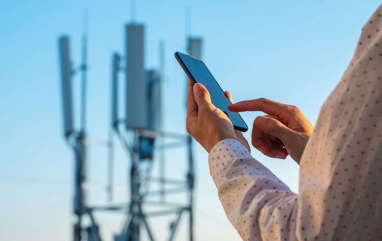 A person using a smartphone with wireless connectivity.