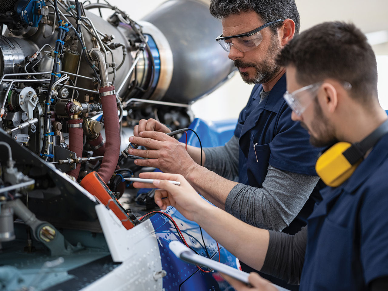 Aircraft mechanics and engineers in the hangar.