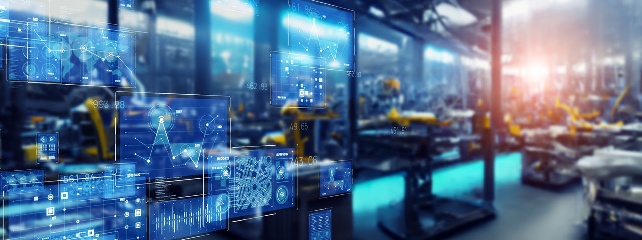 An advanced manufacturing technology control panel in front of a manufacturing line.